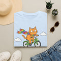 Cat on a Bike T-Shirt — "Off to Teach Coping Skills" Cute Rainbow Scarf Tee